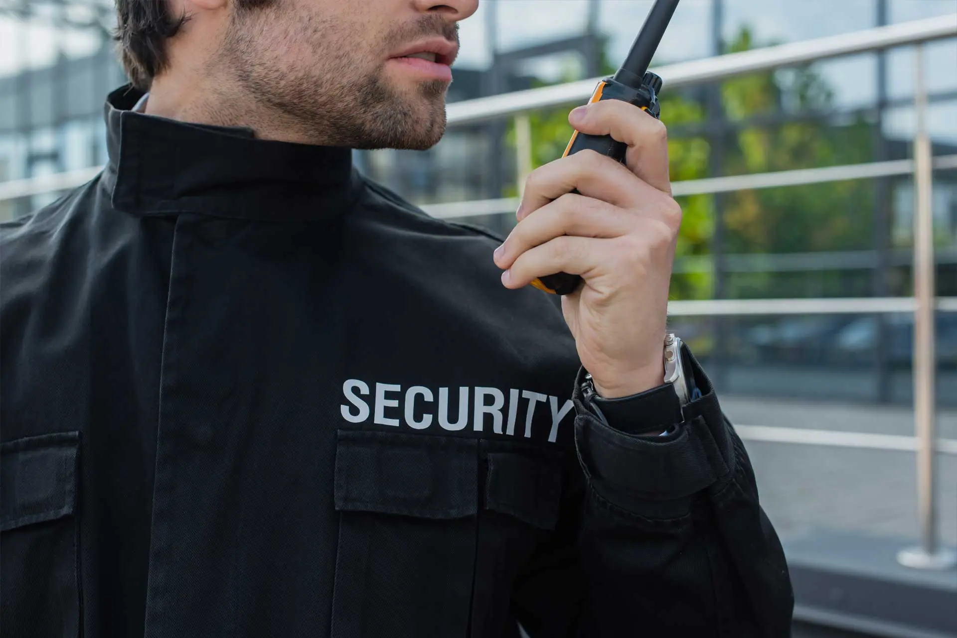 security guard using walkie talkie outdoors